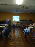 The group listening to previous cases resolved through the help of CrimeStoppers information