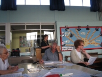 Barry studying the report attentively while Rose listens